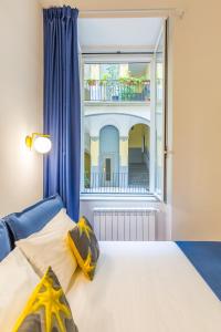 a bedroom with a bed and a large window at Chiatamone Design Apartment by Wonderful Italy in Naples