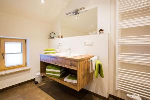 a bathroom with a sink and a mirror at Schleipfnerhof Urlaub auf dem Bauernhof in Bernau am Chiemsee