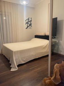 a bedroom with a bed and a mirror at Sea view villa in Preveza +10 photos