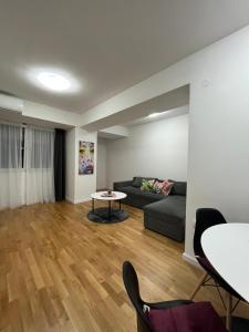 a living room with a couch and a table at Skopje Centar Margarita Luxury Aprtment(Private Parking) in Skopje