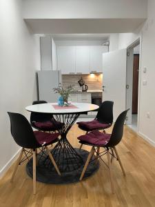 a kitchen with a table and chairs in a room at Skopje Centar Margarita Luxury Aprtment(Private Parking) in Skopje