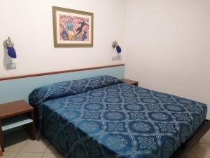 a bedroom with a bed and a picture on the wall at Residence Oltremare in San Benedetto del Tronto