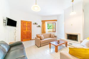 a living room with a couch and a fireplace at Apartment corfu in Lefkímmi