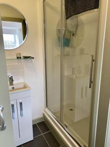 a shower with a glass door in a bathroom at Jollys of Goodrich in Goodrich