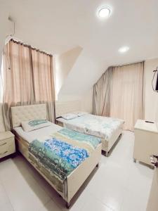a bedroom with two beds in a room at Cottage Tbiliselebi in Ureki +11 photos