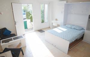 a white bedroom with a bed and a bathroom at Nice House Rent in Saint-Laurent-du-Var