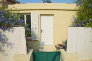 a house with a white door and a table in front of it at Nice House Rent in Saint-Laurent-du-Var