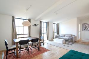 a living room with a table and chairs and a couch at Cozy and Bright Apartments with Private Car Park in Copenhagen