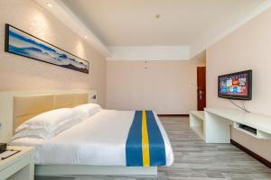 Ένα ή περισσότερα κρεβάτια σε δωμάτιο στο Unitour Hotel, Nanning Dongge Traditional Chinese Medicine No 1 Affiliated
