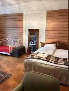 a bedroom with a large bed and a chair at Villa Internationals in Oslo