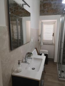 ein Bad mit einem Waschbecken und einem Spiegel in der Unterkunft Villa Rosa in Agropoli