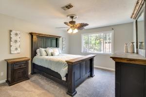 a bedroom with a bed and a ceiling fan at Spacious Biloxi Home with Patio and Private Yard! in Biloxi