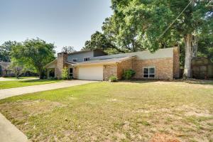 a brick house with a garage and a yard at Spacious Biloxi Home with Patio and Private Yard! in Biloxi