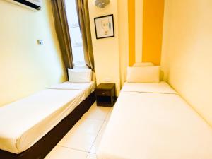 Postel nebo postele na pokoji v ubytování Sun Inns Hotel Puchong + 37 fotografií