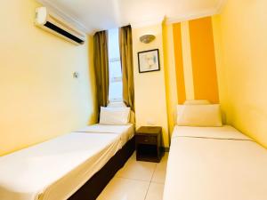 Postel nebo postele na pokoji v ubytování Sun Inns Hotel Puchong