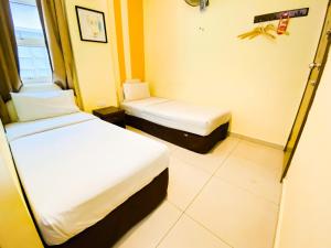 Postel nebo postele na pokoji v ubytování Sun Inns Hotel Puchong