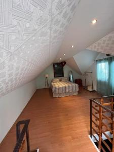 a attic room with a bed and a television at Vikendica Morinj in Donji Morinj