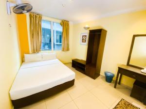 Postel nebo postele na pokoji v ubytování Sun Inns Hotel Puchong