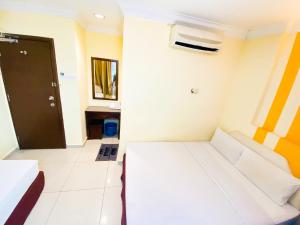 Postel nebo postele na pokoji v ubytování Sun Inns Hotel Puchong
