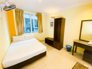 Postel nebo postele na pokoji v ubytování Sun Inns Hotel Puchong