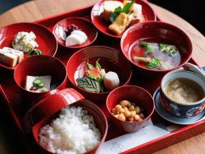 a tray filled with dishes of food on a table at Kyoto Machiya Fukune in Kyoto