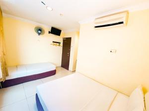 Postel nebo postele na pokoji v ubytování Sun Inns Hotel Puchong