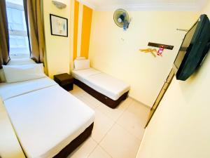 Postel nebo postele na pokoji v ubytování Sun Inns Hotel Puchong