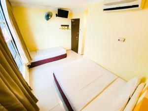 Postel nebo postele na pokoji v ubytování Sun Inns Hotel Puchong