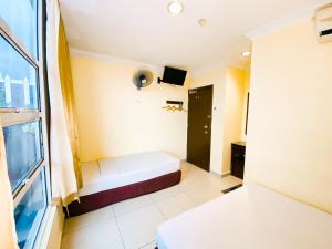 Postel nebo postele na pokoji v ubytování Sun Inns Hotel Puchong
