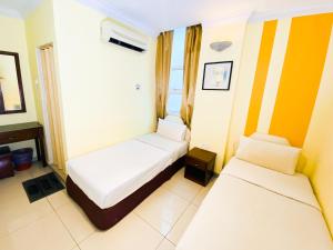 Postel nebo postele na pokoji v ubytování Sun Inns Hotel Puchong