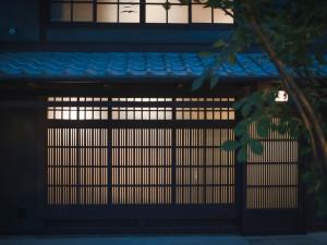 a gate in front of a building at night at Kyoto Machiya Fukune in Kyoto