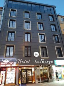 a building with a hotel kuzovaova on a street at Hotel kafkasya in Kars