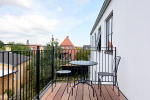 a balcony with two chairs and a table on a building at Cozy and Bright Apartments with Private Car Park in Copenhagen