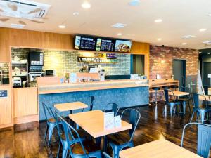 a fast food restaurant with tables and chairs at Hotel Livemax Premium Nagano Ekimae in Nagano