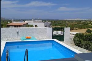 a swimming pool in a villa with a view at Studio Angelika in Glinado Naxos