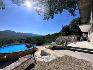 a swimming pool in a yard with a house at Holiday Home - Boanerges Heritage in Blato na Cetini