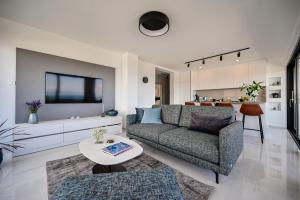 a living room with a couch and a table at Apartments Sea & Stone in Malinska