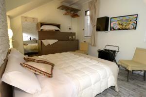 a bedroom with a white bed with pillows on it at Pidkova in Modena