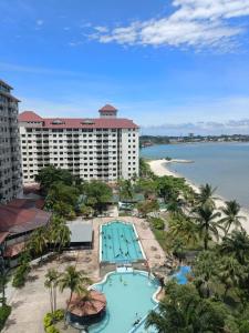 an aerial view of a resort with a pool and a beach at 99 Glory Beach Resort - seaview, poolview, beachfront,wifi in Seremban