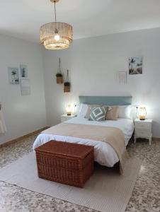 a bedroom with a large bed and a chandelier at Lourido playa in Pontevedra