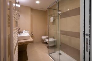 a bathroom with a toilet and a sink and a shower at The Ziba Hotel & Spa in Peschiera del Garda