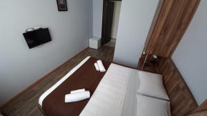 a bedroom with a bed and a tv on the wall at Balu in Kobuleti