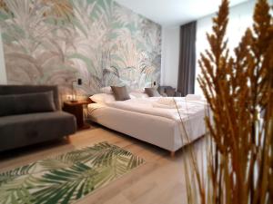 a living room with a white bed and a couch at Alison Apartments (Nr. 24) in Keszthely +86 photos