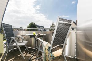 a patio with two chairs and a table on a balcony at Likedeeler Weg 1 Whg 24 in Zingst