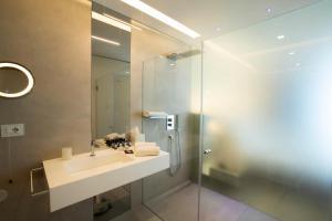 a bathroom with a sink and a shower at Posia Retreat & Spa UNA Esperienze in San Foca