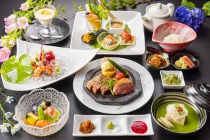 a table filled with plates of food and drinks at Hakone Nanase formerly known as Manatei Hakone in Hakone