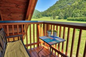 a table and a chair on a balcony with a view at Betlehem Resort in Zgornje Gorje
