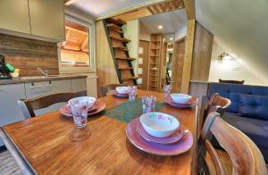a wooden table with plates and bowls on top of it at Betlehem Resort in Zgornje Gorje