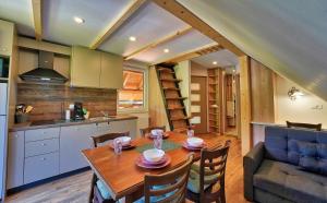 a kitchen and dining room with a wooden table and chairs at Betlehem Resort in Zgornje Gorje