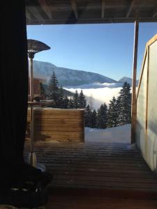 a room with a view of a snow covered mountain at Appartement charme CHAMROUSSE in Chamrousse